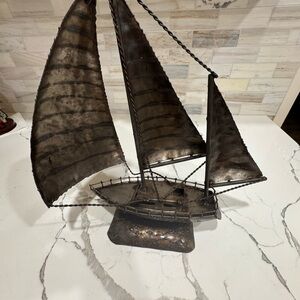 Vintage distressed metal sailboat sculpture.